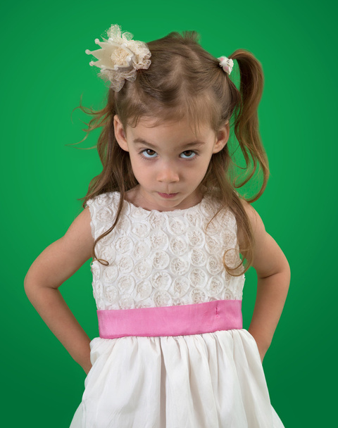 Cute little girl with white dress and a serious look - Фото, изображение