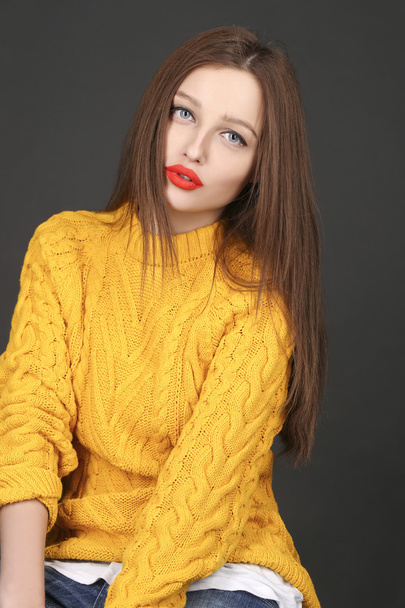 Portrait of brunette woman in yellow jacket with red lips - Фото, изображение