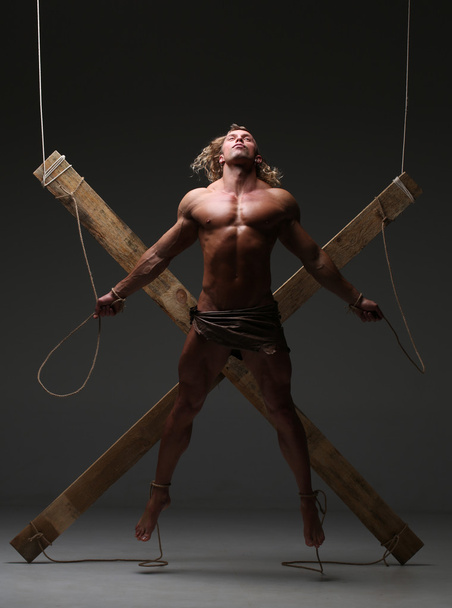 Sexual naked man, muscular, hands tied rope to wooden beams - Valokuva, kuva