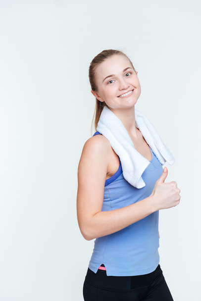 Smiling fitness woman showing thumb up - Foto, afbeelding