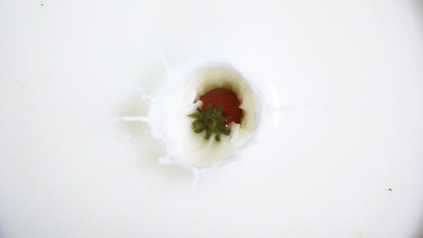 Strawberry dropping into milk - Footage, Video