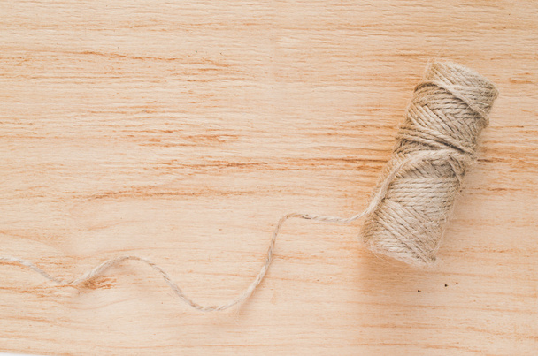 Old scissors and skein jute twine on a wooden background, selective focus, rustic style. - Photo, Image