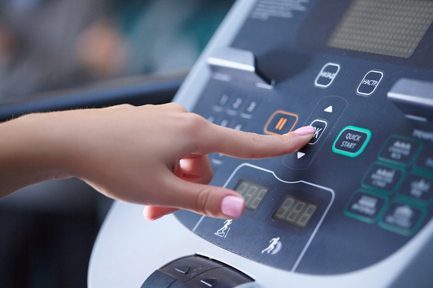 Girl on treadmill presses button - Photo, image