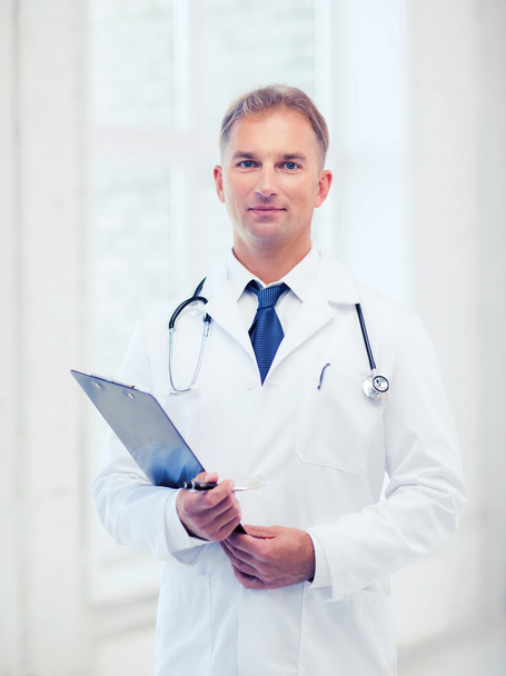 male doctor with stethoscope and clipboard - 写真・画像