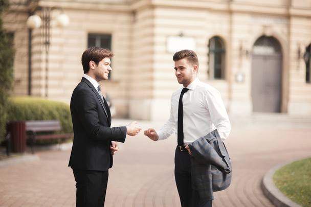 Two stylish businessmen shaking hands in suits - Φωτογραφία, εικόνα