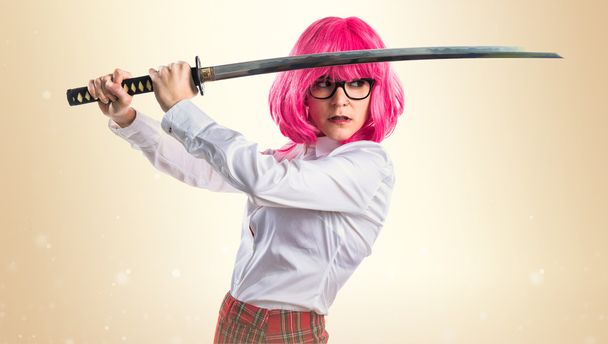 Girl with pink hair holding a katana - Foto, imagen
