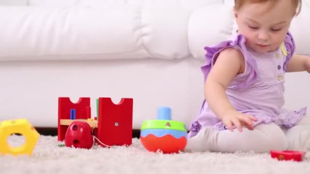 Little cute girl plays with toy for development of thinking - Video