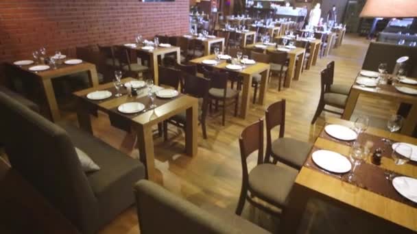 Roomy hall with served tables and walls of bricks in restaurant. - Footage, Video
