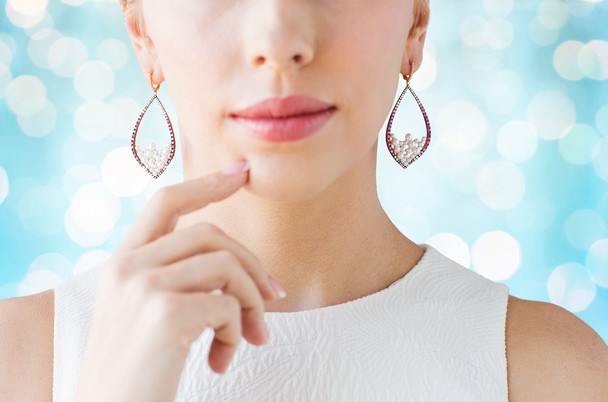 close up of beautiful woman face with earrings - 写真・画像