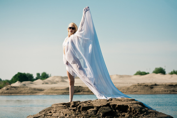 Woman with big white cloth - Foto, imagen