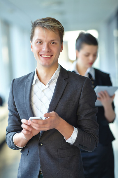 Empresaria con tablet y hombre de negocios con teléfono
 - Foto, Imagen