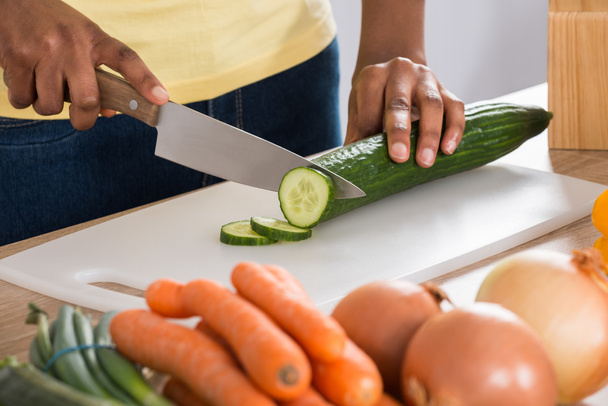Woman Chopping Vegetables In Kitchen - Fotó, kép