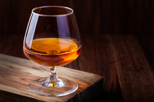 cognac on a wooden background - Photo, Image