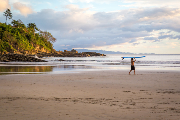 Surfista solitário caminhando para o mar
 - Foto, Imagem