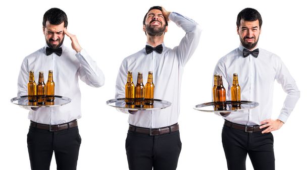 frustrated waiter with beer bottles on the tray  - 写真・画像