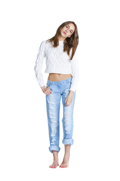 Portrait of a beautiful woman in blue jeans and white sweater - Zdjęcie, obraz