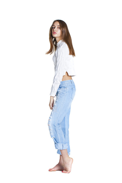 Portrait of a beautiful woman in blue jeans and white sweater - Foto, Bild
