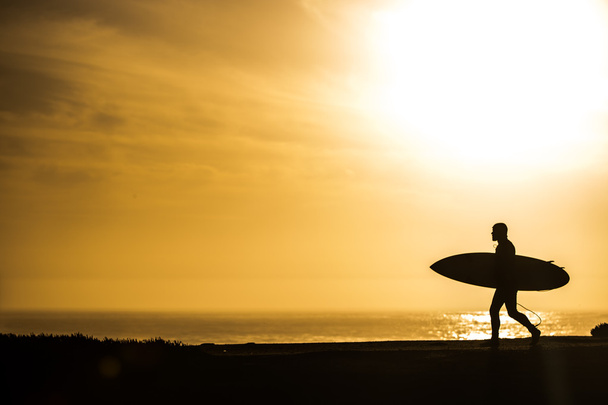 Surfer walking in sunset - Foto, imagen
