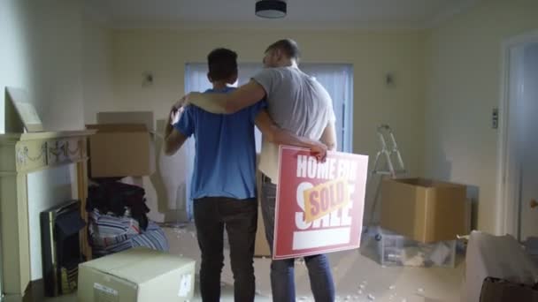 gay couple standing with 'sold' sign - Video, Çekim