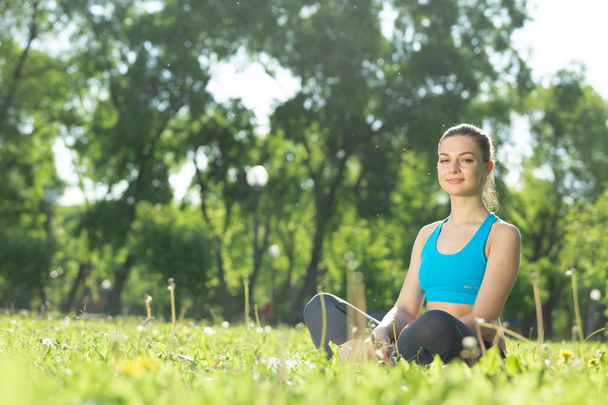 Woman meditating in park - Photo, Image