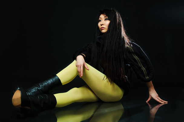 Sitting brunette asian model - Фото, изображение