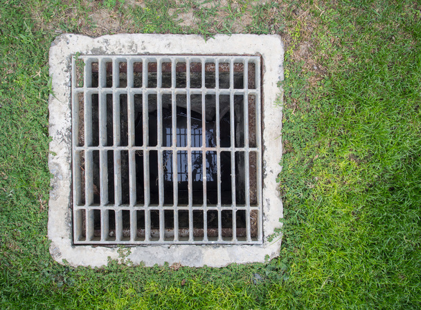 Steel square shape sewer grate on lawn - Photo, Image
