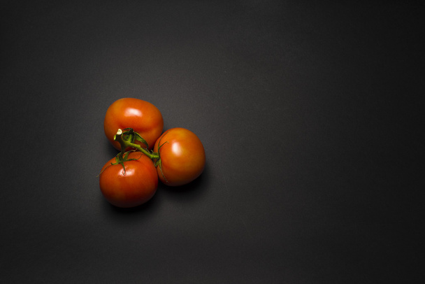 tomatoes on a black table - Foto, immagini