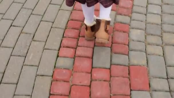 Krásná holčička jde na dlážděném chodníku ve staré části města Evropské. - Záběry, video