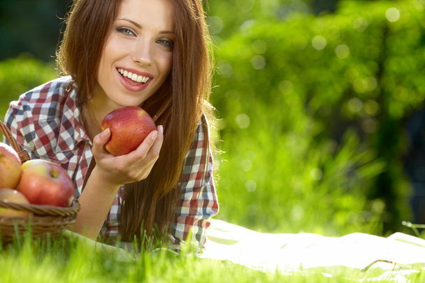 Beautiful woman in the garden with apples - Photo, image