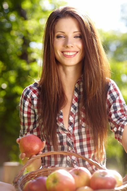 Beautiful woman in the garden with apples - Фото, зображення