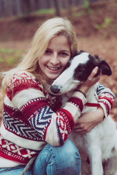 Portrait of beautiful young woman playing with dog outdoor. - Fotoğraf, Görsel