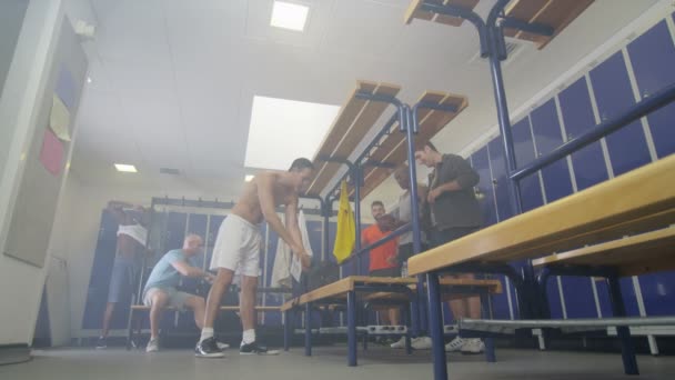 sports players getting changed in locker room - Footage, Video