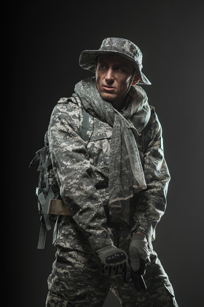 Special forces soldier man with gun on a  dark background - 写真・画像
