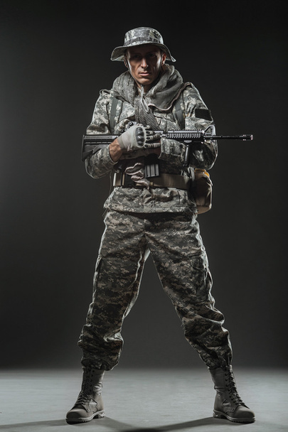 Special forces soldier man with Machine gun on a  dark background - Фото, изображение