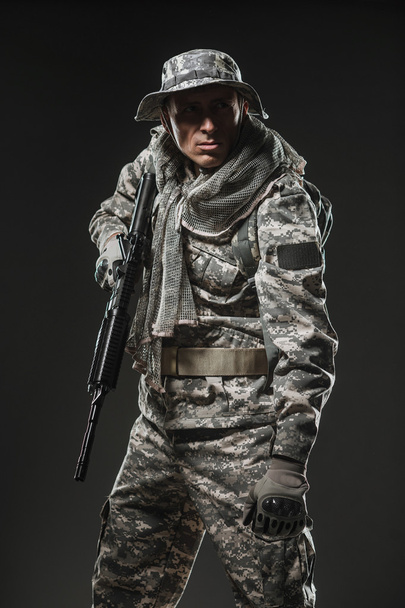 Special forces soldier man with Machine gun on a  dark background - Fotó, kép