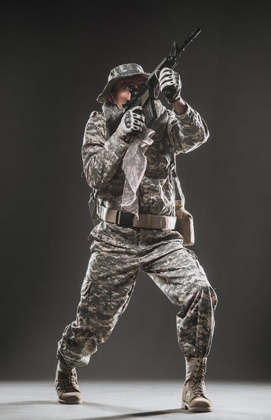 Special forces soldier man with Machine gun on a  dark background - Fotó, kép