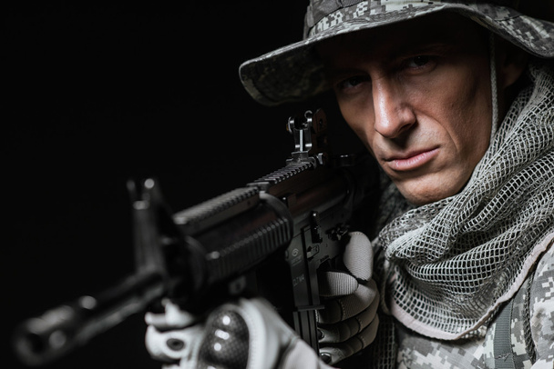 Special forces soldier man with Machine gun on a  dark background - Фото, изображение