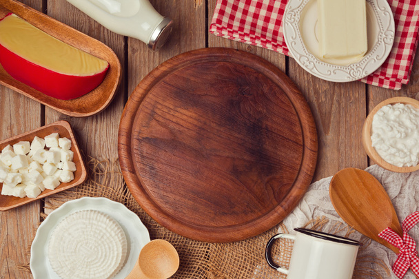 Wooden board with milk and cheese - 写真・画像