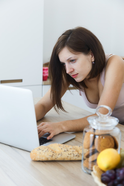 Woman use laptop at the kitchen - Φωτογραφία, εικόνα