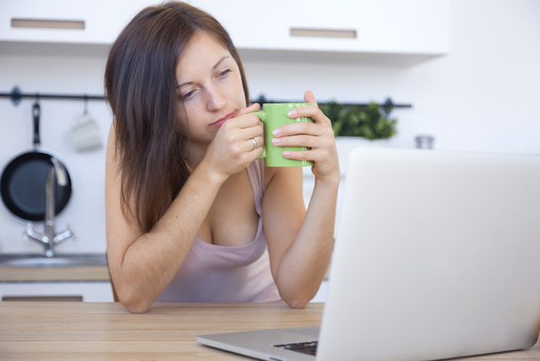 Woman drink tea at the workplace at home - Photo, Image
