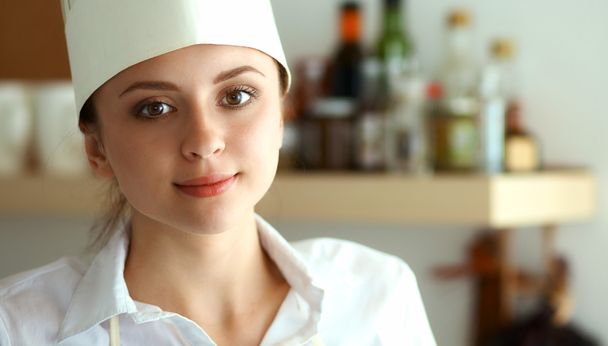 Chef woman portrait with  uniform in the kitchen - Фото, изображение