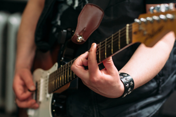Musician playing six string electric guitar - Foto, Bild