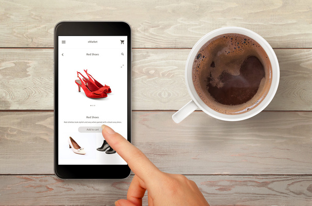 Woman shopping shoes with smart phone. Top view scene with coffee. - Photo, Image