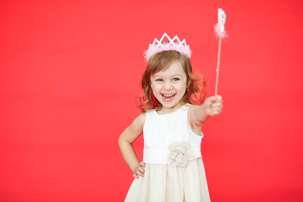 Little girl holding a magic wand in her hand - 写真・画像