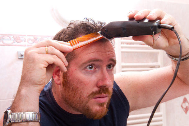 man grooming his hair with electric razor - Фото, зображення