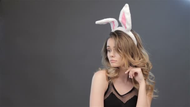 Girl shows surprise with bunny ears on her head - Footage, Video