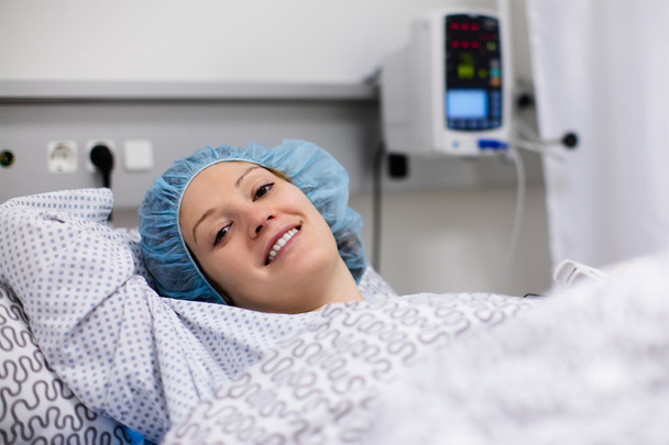 Young woman in hospital recovery room after surgery - Zdjęcie, obraz