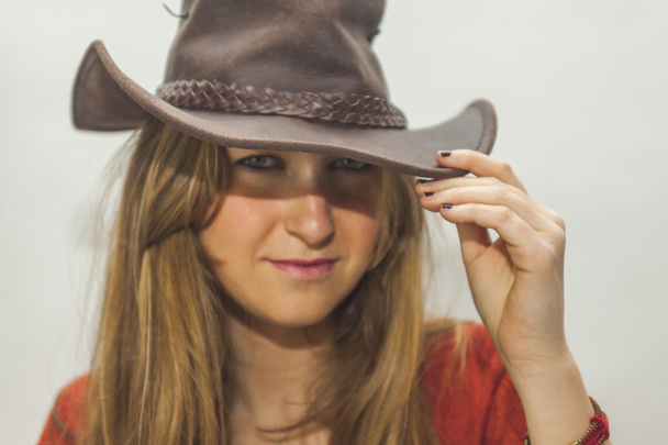 Portrait of beautiful blonde woman with a cowboy hat shoot in st - Fotoğraf, Görsel