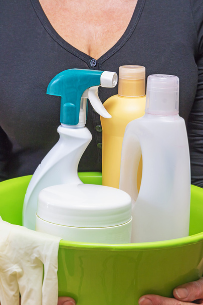 Woman is holding household cleansers - Photo, Image