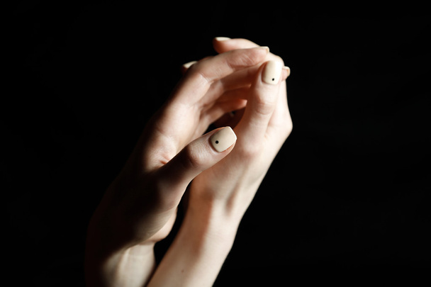 Female hands on black background shows gestures - Фото, изображение